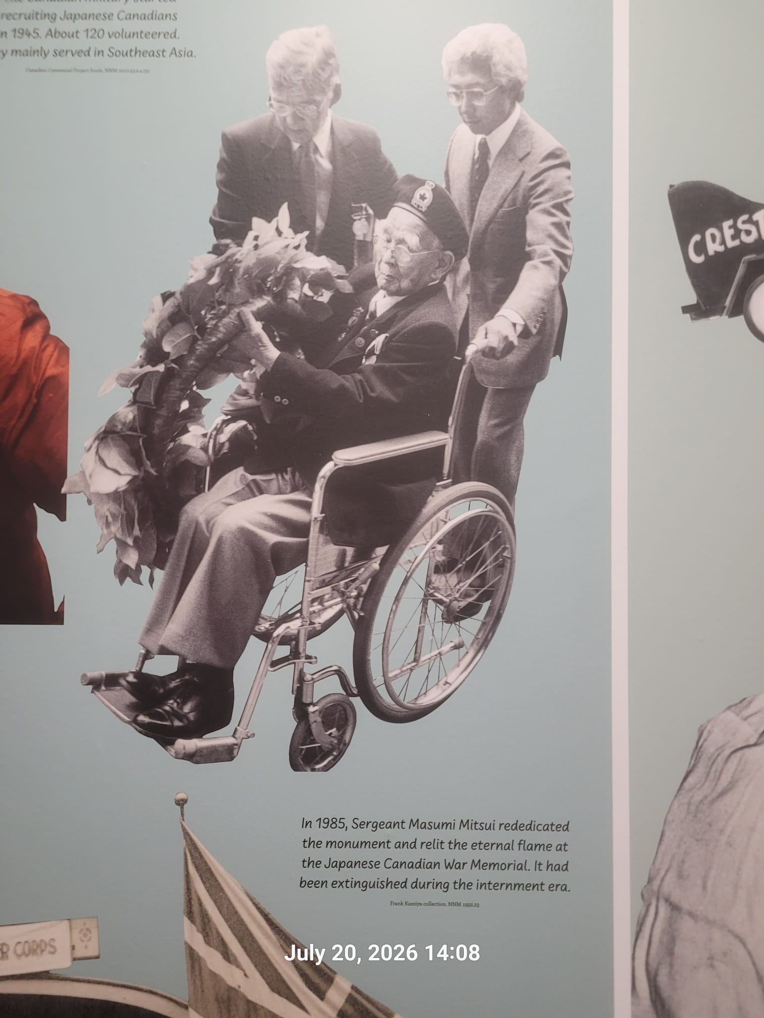 Sergeant Masumi Mitsui in later life, seated in a wheelchair and holding a wreath at the Japanese Canadian War Memorial in Stanley Park, Vancouver rededication ceremony